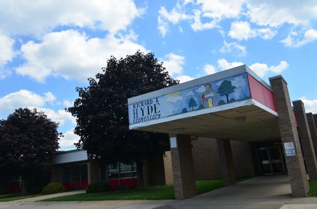 Two Moon Area School Board members and a local parent have filed a lawsuit against the district claiming the repurposing of Hyde Elementary School violates state law.