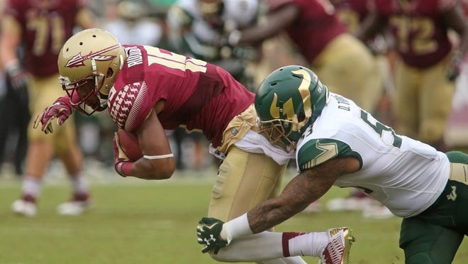 Florida State’s Travis Rudolph is tackled by South Florida’s Danny Thomas after making a reception in the third quarter of an NCAA college football game, Saturday, Sept. 12, 2015 in Tallahassee, Fla. Florida State won the game 34-14. (AP Photo/Steve Cannon)