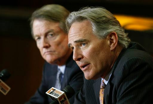 In this Dec. 15, 2013, file photo, University of Texas athletic director Steve Patterson, right, and school president Bill Powers discuss a search for a new head football coach during an NCAA college football news conference in Austin, Texas. A person with direct knowledge of the decision says Texas athletic director Steve Patterson has been fired. The person spoke Tuesday, Sept. 15, 2015, on condition of anonymity because the school had not announced the move. The Associated Press