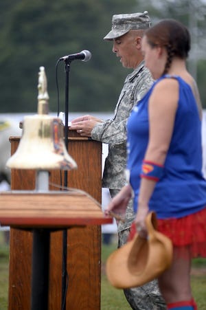 U.S. Army Col. Mark Merlino takes part in the reading of names of fallen members or the military as part of a pre-race ceremony at Memorial Field in Dedham during Saturday morning's Massachusetts Run for the Fallen. Wicked Local Photos/Sean Browne