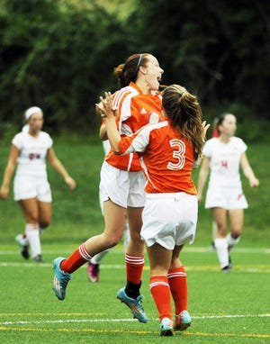 Newton South freshman Audrey Lavey, left, cheers with freshman Willa Frantzis after Lavey scored a goal in their game against Waltham at Falzone Soccer Field on Thursday. Wicked Local Staff Photo/Sam Goresh
