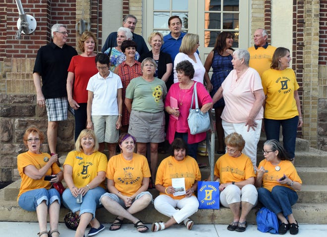 The Duffy School, built in 1870, has been transformed into senior, affordable housing. The new residents, the developer, MEND, and township officials celebrate the grand opening of the restored, renovated and repurposed building. Former students, teachers and school employees get ready to pose for a picture in front of school. Photo by William Johnson