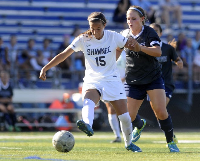 Christina Corsi of Shawnee and Claire McEachern (11) of Timber Creek battle for the ball in the first half of Wednesday's game at Shawnee High School.