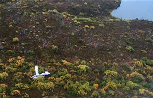 This Sept. 15, 2015 photo provided by Alaska State Troopers shows an aerial view of a small plane that crashed near a lake in rural southwest Alaska, killing three travelers from California and Pennsylvania and injuring seven others aboard, some critically. The De Havilland DHC-3 Turbine Otter was taking off for a fishing trip when it went down outside the tiny town of Iliamna, 175 miles southwest of Anchorage, National Transportation Safety Board Alaska Chief Clint Johnson said. (Alaska State Troopers via AP)