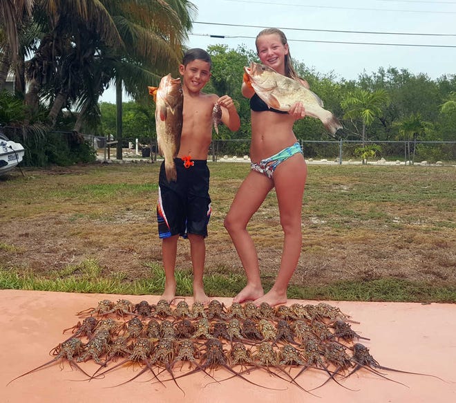 CONTRIBUTED Kayden Ryan, left, and Ryan Mae Essery, with a couple of nice grouper and a bucketful of Florida lobster, caught during the August mini-season in the Keys.