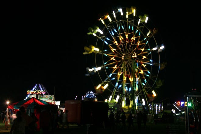 Midway rides illuminate the night during opening night of the 61st annual Canton Friendship Festival on Wednesday. Tonight is Bracelet Night and performances by Sidewalk Prophets and About a Mile, beginning at 6 p.m.