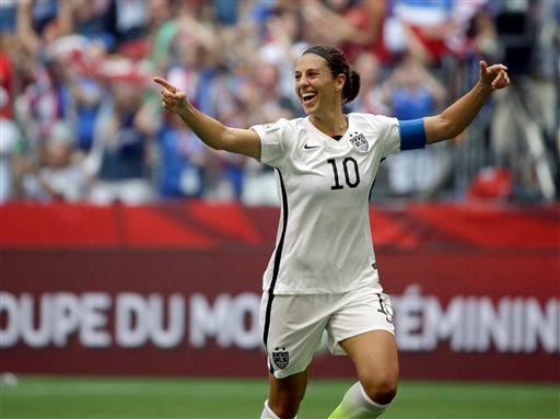 FILE - In this Sunday, July 5, 2015, file photo, United States' Carli Lloyd celebrates after scoring her third goal against Japan during the first half of the FIFA Women's World Cup soccer championship in Vancouver, British Columbia. Lloyd is working on a memoir that Houghton Mifflin Harcourt will release in fall 2016. The publisher announced Thursday, Aug. 20, 2015, that the book, currently untitled, will cover her rise from nearly quitting soccer in 2003 and her emphasis on physical and mental strength. An edition for young readers is also planned.