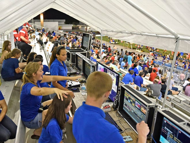 During the broadcast producer Alexis Federico, 17, left in middle, points to a shot that has the correct player and asking for the players name as Yami Regalado, 16, middle back, directs the second half of the broadcast. Abrielle Leeder, 17, switching, listening to the director and changing cameras accordingly as Patrick Brady, 16, front middle runs the graphics computer, bringing up the name of the player asked for by the producer/director. (September 11, 2015; STAFF PHOTO / THOMAS BENDER)