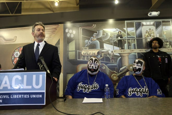 From left, Michael J. Steinberg, legal director for the ACLU of Michigan, and Insane Clown Posse Members Joseph Bruce aka Violent J, and Joseph Utsler, aka Shaggy 2 Dope, members of the Insane Clown Posse listen in Detroit, Wednesday, Jan. 8, in 2014. A court has ruled that the band's fans have been unfairly targetted by legal authorities. The Associated Press