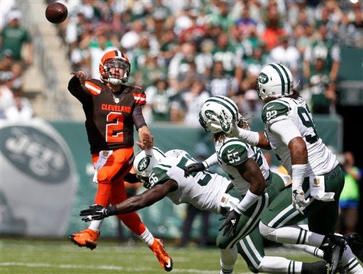 Cleveland Browns quarterback Johnny Manziel (2) throws a pass while evading New York Jets inside linebacker Demario Davis (56), Lorenzo Mauldin (55) and Kevin Vickerson (92) during the first half of an NFL football game Sunday, Sept. 13, 2015 in East Rutherford, N.J. (AP Photo/Kathy Willens)