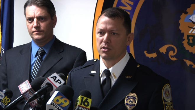 Pocono Regional Police Chief Chris Wagner, right, and Monroe County Assistant District Attorney Michael Rakaczewski hold a news conference at the police station in Pocono Summit, Pennsylvania, Tuesday to discuss charges in the hazing death of New York City college student Chun “Michael” Deng. A panel recommended third-degree murder charges against the Pi Delta Psi fraternity and five students at Baruch College in the Dec. 8, 2013, death of Deng. Thirty-two others face charges ranging from aggravated assault to hazing, Pocono Mountain Regional Police said in a statement.