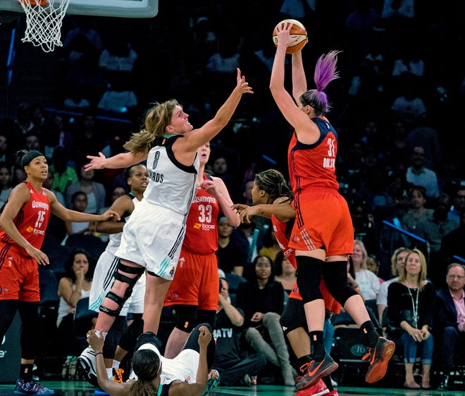 Liberty's Carolyn Swords, left, goes after a rebound that was grabbed by the Mystics' Stefanie Dolson in the first half of Friday night's Eastern Conference playoff game at Madison Square Garden. The Associated Press