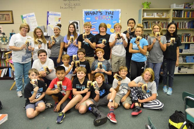 Patti Kroeger's seventh grade civics class with their pocket constitutions donated by the West Florida chapter of the DAR.
