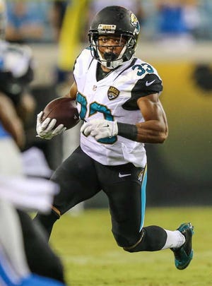 Gary McCullough for The Times-Union Jaguars running back Corey Grant runs the ball against the Lions during the second half of a preseason game at EverBank Field.