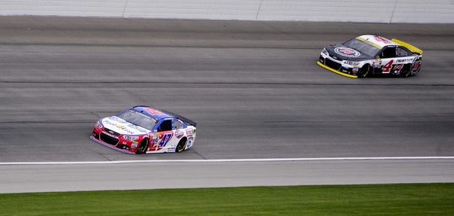 AJ Allmendinger, left, and Kevin Harvick get their practice runs in Friday before rain washed out qualifying sessions that evening for Sunday's race at Chicagoland. (AP Photo/Matt Marton)