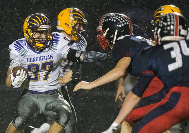 Hononegah's Christian Fausel (37) fends off Belvidere North's defense during the game Friday, Sept. 18, 2015, at Belvidere North. SUNNY STRADER/STAFF PHOTOGRAPHER/RRSTAR.COM