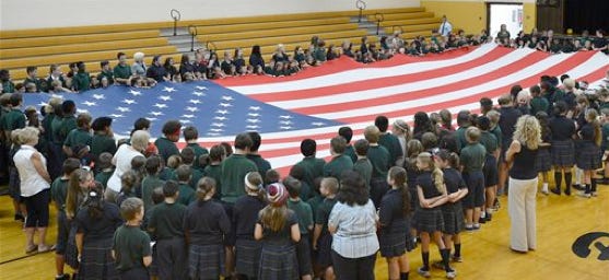 Students at Blessed Sacrament School in Erie, Pa., help unfurl a 30-by-60-foot American flag on Thursday, the 228th anniversary of Constitution Day.