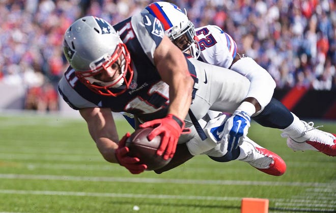New England Patriots wide receiver Julian Edelman (11) dives past Buffalo Bills free safety Aaron Williams (23) for a touchdown during the second half Sunday, Sept. 20, 2015, in Orchard Park, N.Y.