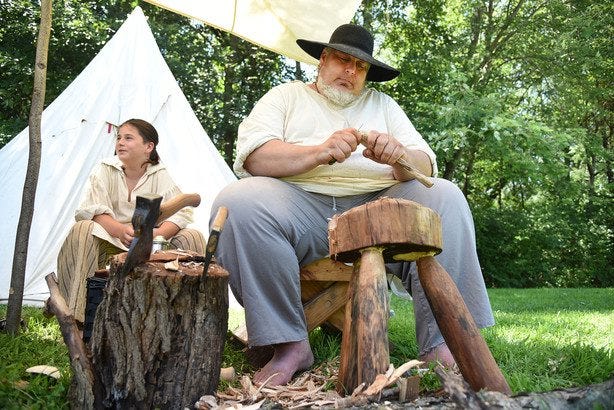 James Mead, dressed as a bodger, or woodworker, and his son, Gibeon, sit in their camp during a re-enactment of the first French and Indian War at Fort Crevecoeur. Sarah Gardner/GateHouse Media Illinois