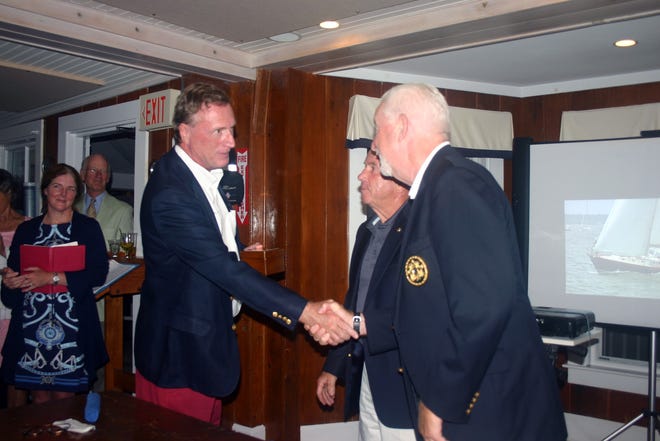 Current Beverly Yacht Club Commodore Larry Hall and incoming Commodore Alan McLean congratulate Rob McAlpine, skipper of Sparky, a Hinckley 42 that rescued the crew of Restive offshore after this year's Marion Bermuda race. BARBARA VENERI/STANDARD-TIMES SPECIAL/SCMG