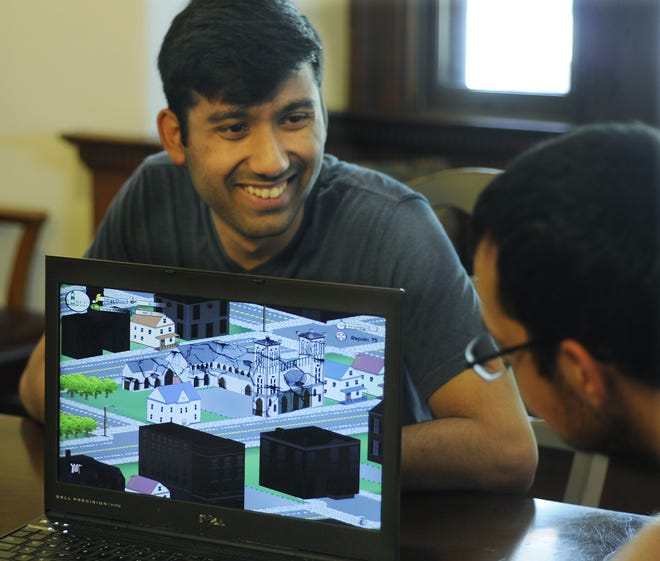 Shiva Mendonca smiles during the presentation to Preservation Worcester of the video game "Preserve!" that he and four other Becker College students created. His role was to research the properties to develop all 206 questions for the game and write all of the text. T&G Staff/Christine Peterson