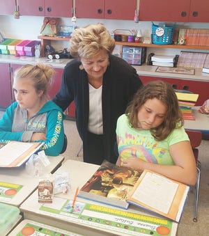 New York State Board of Regent Beverly Ouderkirk, center, visits with students Kendra Smith, left, and Brianna Battisti, right, in a fourth-grade classroom at Oppenheim-Ephratah-St. Johnsville Elementary School last week. Ouderkirk visited the school due to its placement on the “persistently dangerous” list. PHOTO COURTESY/OPPENHEIM-EPHRATAH-ST. JOHNSVILLE CENTRAL SCHOOL DISTRICT