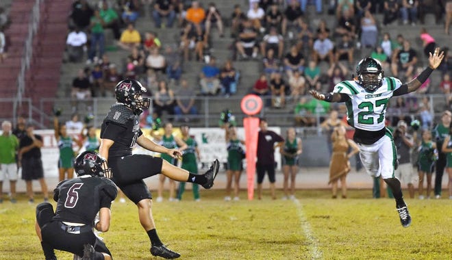 With the help of teammate Jordan Ewing, left, Navarre kicker Brady Hammel kicks a field goal past Choctawhatchee's 

Myles Betts to put the Raider's up 16-14 over the Indians and clinch Friday night's game.