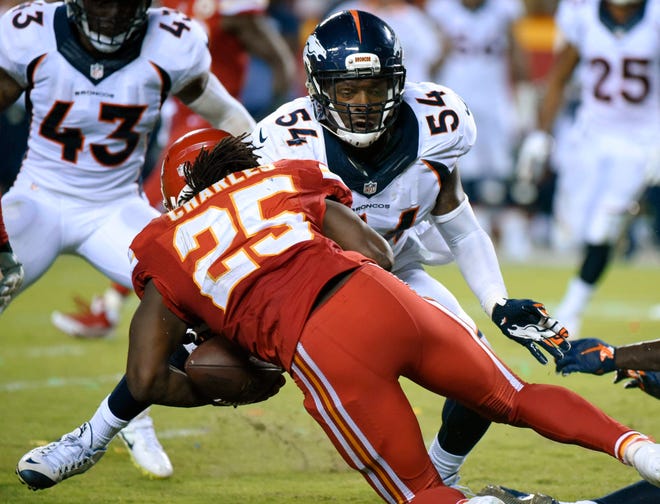 Kansas City Chiefs running back Jamaal Charles was tackled by Denver Broncos linebacker Brandon Marshall (54) and fumbled the ball for a turnover late in the game that was returned for a touchdown. Denver won 31-24. (AP Photo/Ed Zurga)