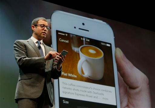 In this March 18, 2015 file photo, Adam Brotman, Starbucks chief digital officer, talks about the company's new mobile ordering app at Starbucks Coffee Company's annual shareholders meeting in Seattle. The Seattle-based coffee chain says its mobile app that lets people order and pay in advance will be available nationally starting Tuesday, Sept. 22, 2015. (AP Photo/Ted S. Warren, File)