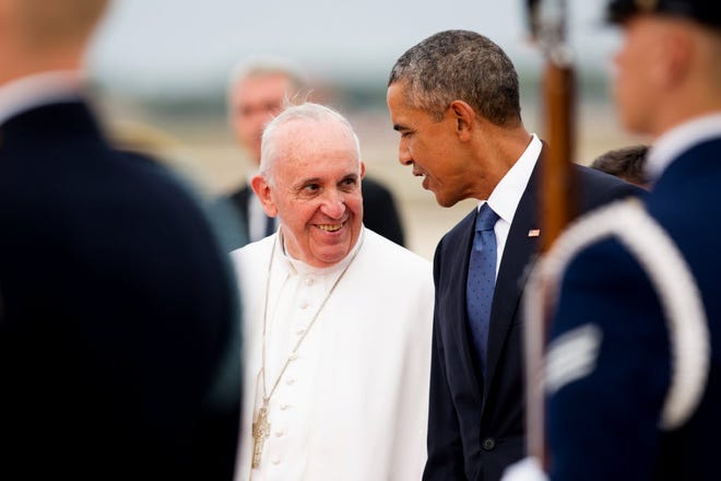 Pope Francis talks with President Barack Obama on the tarmac at Andrews Air Force Base in Maryland, shortly after the pope arrived for a tour of the U.S. on Tuesday.
