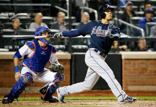 Atlanta Braves' Jace Peterson hits a fifth-inning solo home run as Mets catcher Kevin Plawecki looks on Tuesday night. Associated Press