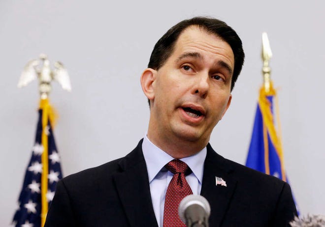 FILE - In this Sept. 21, 2015 file photo, Wisconsin Gov. Scott Walker announces in Madison, Wis. that he is suspending his Republican presidential campaign. Walker and Rick Perry entered the 2016 presidential race with a combined 18 years of experience as governors. They exited the Republican primary, the first candidates to do so, with negligible support from voters and dwindling bank accounts. (AP Photo/Morry Gash, File)