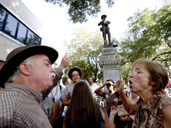 In this July 9 file photo, Jeanne Galligan, right, argues with a man who did not want to give his name about the removal of a Confederate statue outside the Alachua County Administration building in Gainesville.
