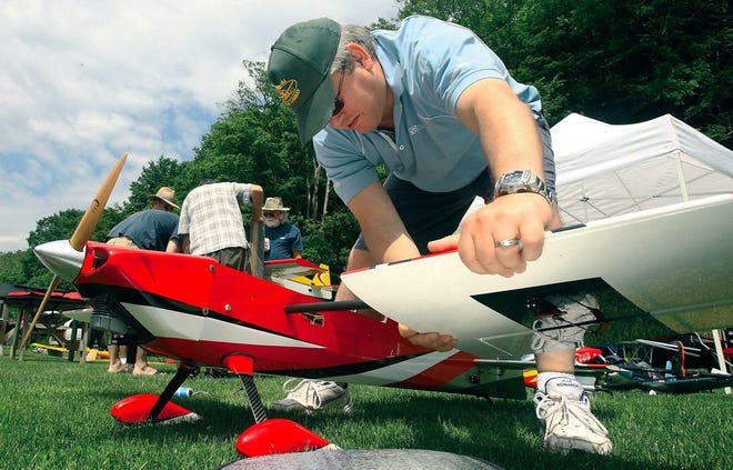 The Roxbury Area Model Airplane Club meets regularly at Hialeah Airpark in Delaware Water Gap National Recreation Area. Stefano Salvatici of East Windsor, N.J., attaches one of the wings as he prepares to fly his plane. (Pocono Record file photo)