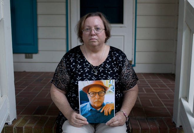 Kathie Rozar holds a photo of her husband, Larry Rozar, at her home in Knightdale, North Carolina. Larry Rozar was killed by his roommate in his assisted living facility. (Jill Knight/Raleigh News & Observer/TNS)