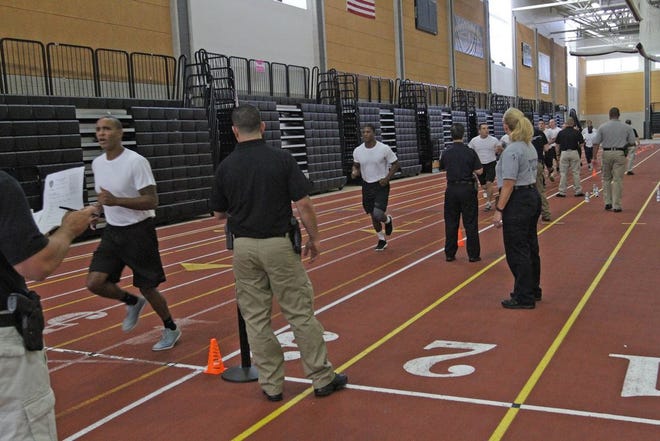 Police candidates go through the running part of the agility test on Saturday. In addition to a mile-and-a-half run, candidates also had to do a 300-meter sprint.