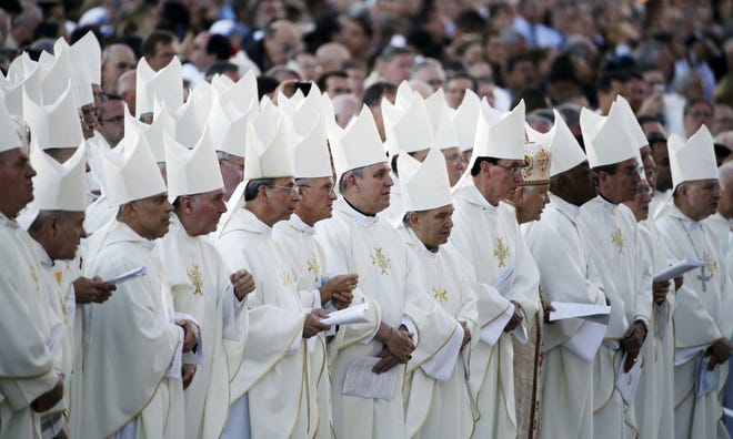 Bishops follow along during a Mass conducted by Pope Francis outside the Basilica of the National Shrine of the Immaculate Conception on Wednesday in Washington. AP Photo/David Goldman