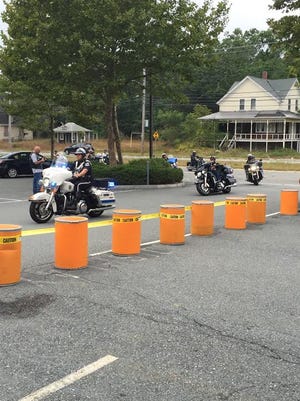 Police officers escort the riders back to the Minuteman Harley parking lot in Dartmouth.
