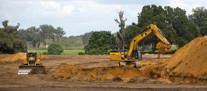 More land is being developed in the industrial park where FedEx is being finished Wednesday afternoon September 23, 2015. Construction workers with Global Contracting Group LLC out of Wildwood, FL, was busy moving dirt and filling trenches on the property just North of the FedEx industrial park. (Doug Engle/Ocala Star-Banner)2015.