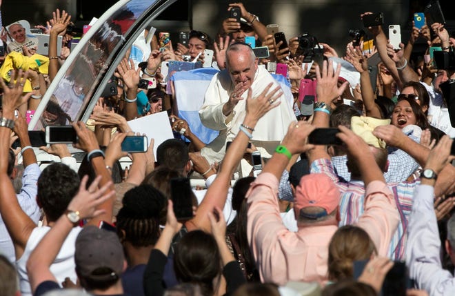 Pope Francis arrives in the popemobile at the Basilica of the National Shrine of the Immaculate Conception in Washington on Wednesday for the Canonization Mass for Junipero Serra, a Franciscan friar. THE ASSOCIATED PRESS