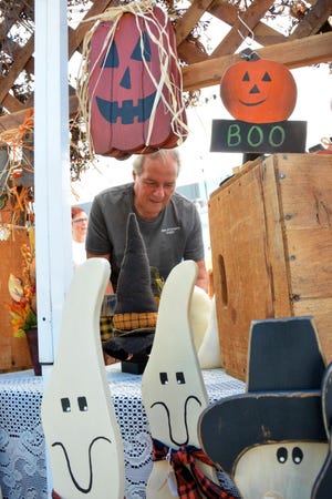 Lou Palena of Town and Country Crafts prepares his booth during last year's Evesham Harvest Fest, held along Main Street.