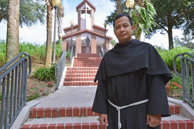 The Rev. Nelson Javier poses outside of the sanctuary at St. Patrick Catholic Church on Wednesday in Mount Dora.