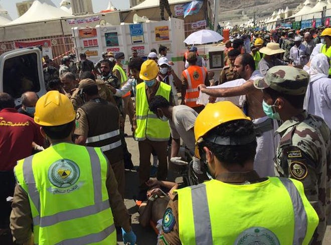 In this image posted on the official Twitter account of the directorate of the Saudi Civil Defense agency, rescuers respond to a stampede that killed and injured pilgrims in the holy city of Mina during the annual hajj pilgrimage on Thursday, Sept. 24, 2015.