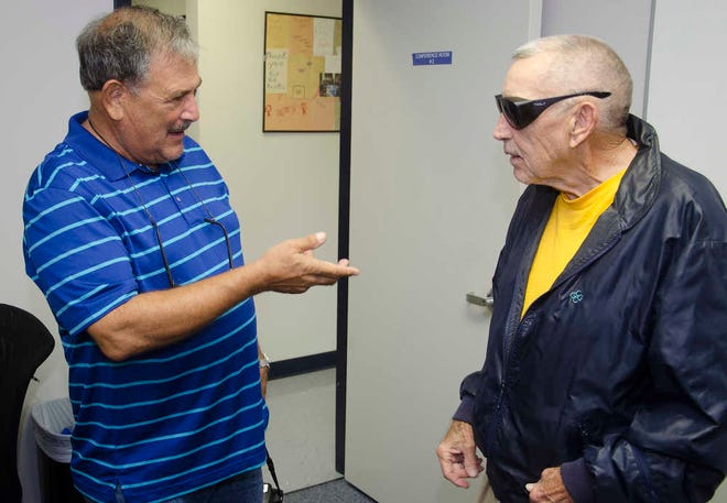 PETER.WILLOTT@STAUGUSTINE.COMLongtime area tennis coach Nick Perpich, right, talks with his student Bernie Levy at an event held at St. Johns County Recreation and Parks Department headquarters in St. Augustine on Thursday, Sept. 24, 2015. Popich was recognized for his coaching in the county.