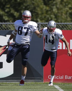 Rob Gronkowski, left, and wide receiver Chris Harper, right, stretch during a recent practice at Gillette Stadium. The Associated Press