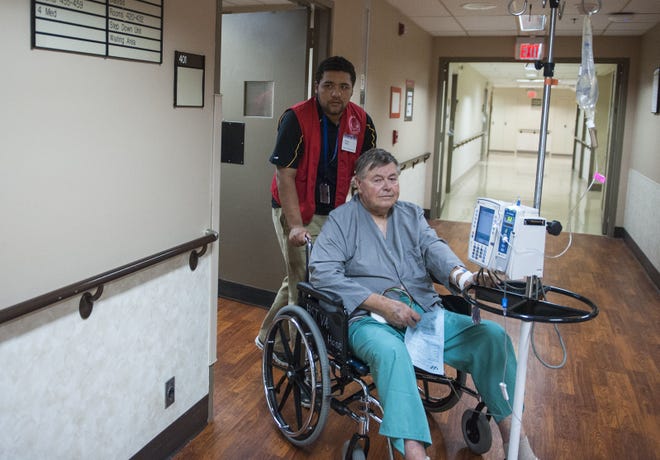On duty at Truman Memorial Veterans’ Hospital, volunteer Isaac Welch transports Trenton resident and patient Earl Nance after an X-ray appointment Sept. 18.