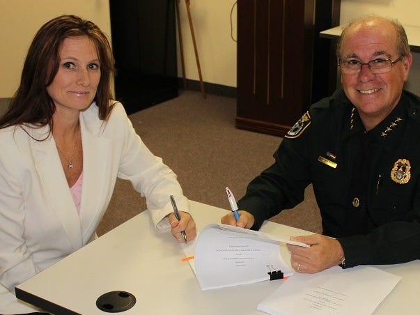 Coastal Florida Police Benevolent Association & Public Employees Association chapter president Kimberly Fitzpatrick and Flagler County Sheriff Jim Manfre sign a new three-year labor agreement that will cover most Sheriff's Office employees. PHOTO PROVIDED/FLAGLER COUNTY SHERIFF'S OFFICE