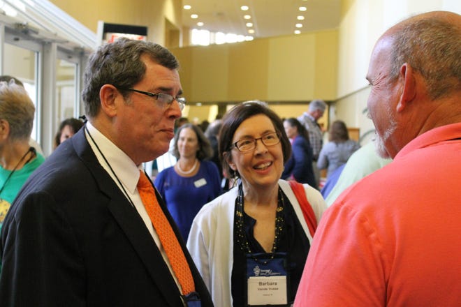 Holland Mayor Bob VandeVusse and his wife, Barbara, chat with visitors at the America in Bloom Symposium Thursday night, Sept. 24, at the Doubletree Hotel in Holland. Andrea Goodell/Sentinel Staff