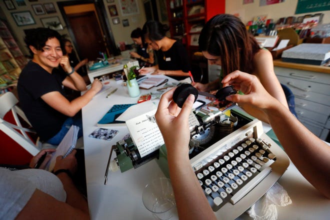 Margaret Haas, right, changes the ribbon on her typewriter as she types a letter to a penpal in Chicago during the monthly gathering of the L.A. Penpal Club at Paper Pastries Atelier in Los Angeles. (Mel Melcon/Los Angeles Times/TNS)