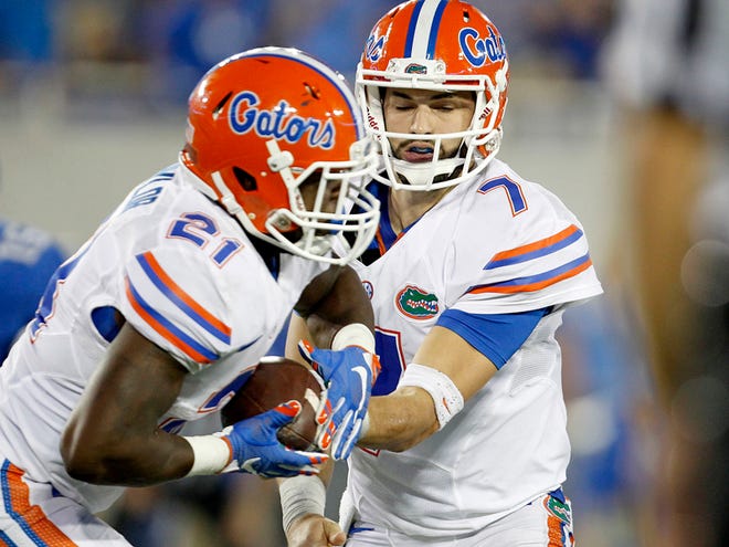 Florida quarterback Will Grier hands the ball off to running back Kelvin Taylor against Kentucky last Saturday. Both need to step up today vs. the Vols.